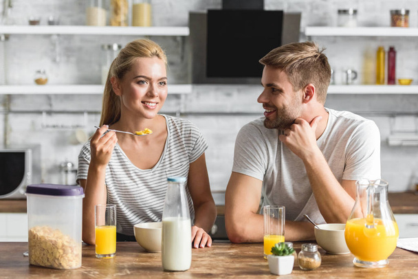 pareja alegre desayunando sano en la cocina
  - Foto, Imagen
