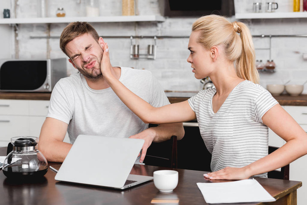 young woman slapping boyfriend during quarrel at home  - Foto, Imagem