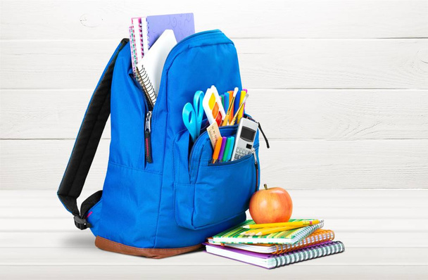 School Backpack with stationery on wooden table - Zdjęcie, obraz