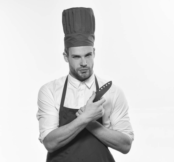 Cook with curious face holds knife. Kitchenware and cooking concept. - Fotografie, Obrázek