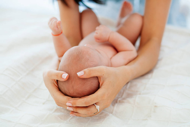 an infant on father's hands on a white background - Zdjęcie, obraz