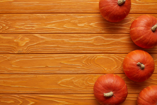 top view of whole ripe pumpkins on wooden background - Photo, Image