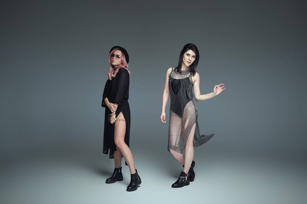 Two fashionable girls wearing black trendy outfits posing - Foto, Imagem