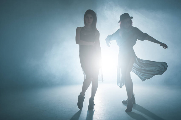 Dancing girls moving in fume and lights   - Valokuva, kuva