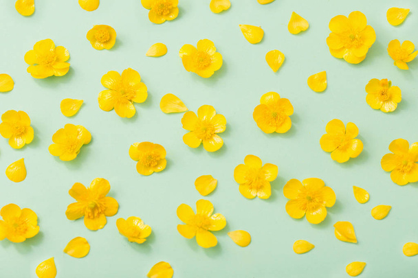 yellow buttercups on green paper background - Zdjęcie, obraz