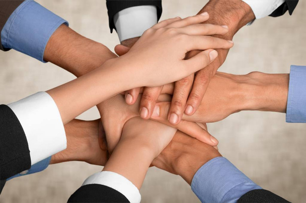 People stacking hands on light background  - Photo, Image