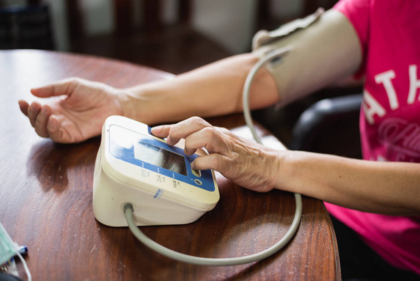 La donna si prende cura della sua salute controllando la pressione sanguigna
 - Foto, immagini