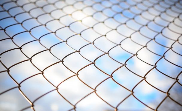 Blue sky behind a metal grate, background - Photo, Image