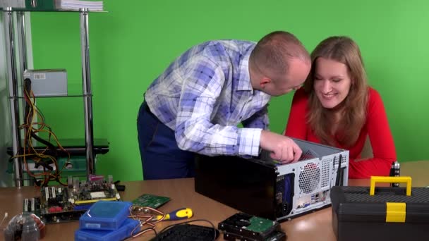 Man helping his colleague office woman to repair computer. girl flirting - Footage, Video