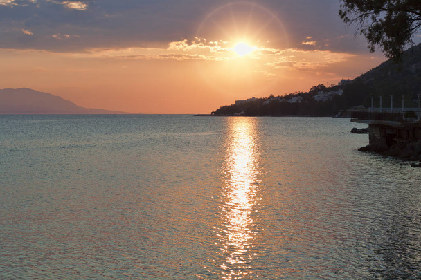 Sunset over the Corinthian Gulf of the Ionian Sea. View from the waterfront of Loutraki, Greece - Fotó, kép
