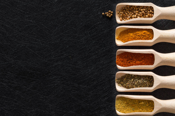 Herbs, spices and food additives on a dark background with an empty place - Foto, imagen