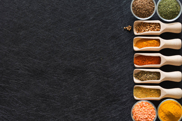 Herbs, spices and food additives on a dark background with an empty place - Photo, Image