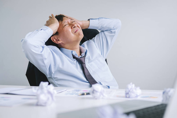 Feeling sick and tired, Senior businessman depressed and exhausted, businessman at his desk frustrated with problems with a pile of work and keeping eyes closed while sitting on office. - Foto, Bild