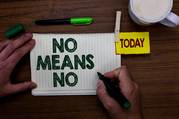 Word writing text No Means No. Business concept for Stop abuse gender violence Negative response Sexual harassment Man holding marker notebook clothespin reminder wooden table cup coffee - Photo, Image
