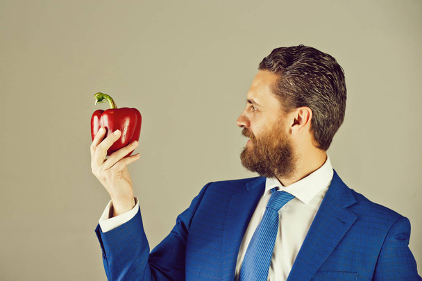 businessman or man with beard holding red vegetable, pepper - Fotografie, Obrázek