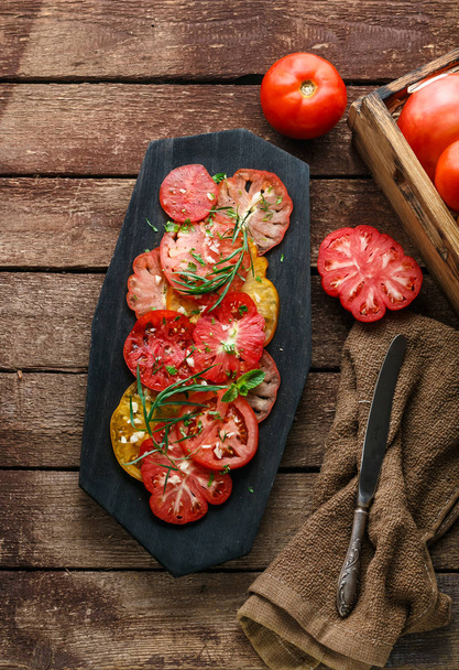 Tomato sliced on a plate. Top view - Φωτογραφία, εικόνα