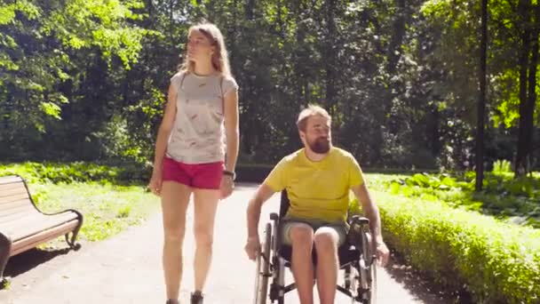 Portrait of happy young disable man on a walk in the park - Footage, Video