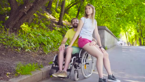 Young disable man on a walk in the park with his wife - Footage, Video