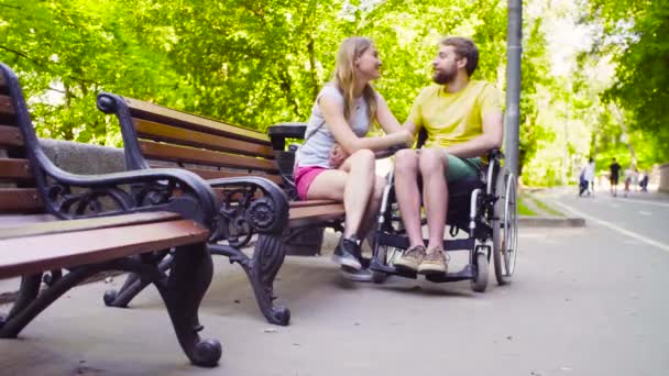 Young disable man with his wife in the park - Footage, Video