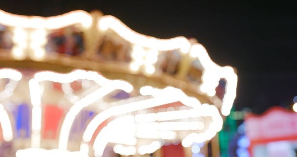 Vue floue du carrousel dans le parc d'attractions en soirée
 - Photo, image