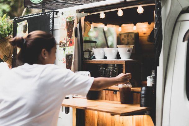 Selected focus drip coffee cup woman buying a coffee from a coffee food truck Small SME concept. - Photo, Image