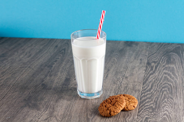 Cookies and a glass of milk on a wooden table - Foto, imagen