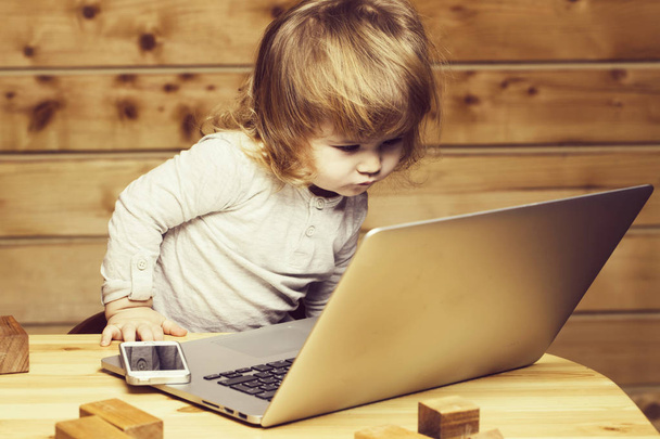 Small boy with computer and phone - Foto, Imagen