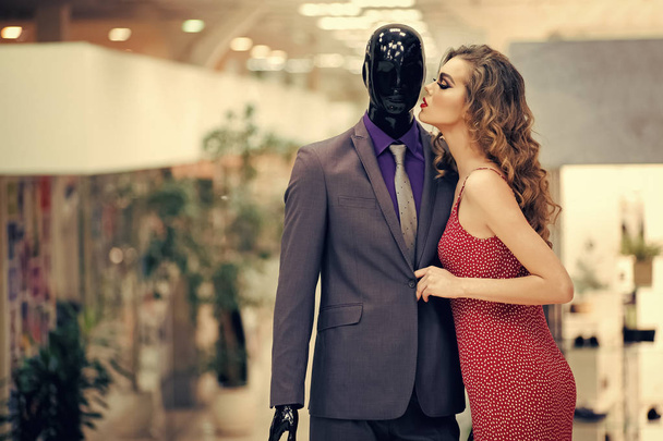 Sensual woman with male mannequin in clothing shop - Fotografie, Obrázek