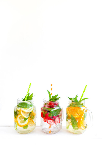 Fresh lemonade with summer fruits and berries on white background - Fotoğraf, Görsel