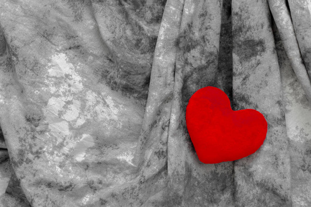 Red heart on grey textile, close-up , valentine day concept  - Fotografie, Obrázek