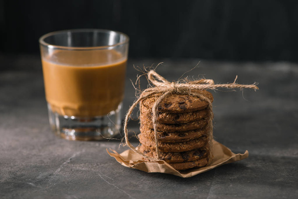Tasty cookies and glass of coffee with milk on a plain background - Fotografie, Obrázek