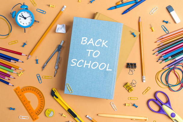 Back to school concept with books and school supplies on yellow background. Top view. - Foto, afbeelding