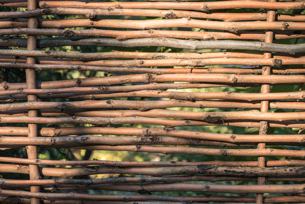 close-up view of beautiful decorative brown wicker fence background - Zdjęcie, obraz