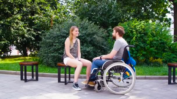 Young disable man with his wife sitting in the park - Footage, Video