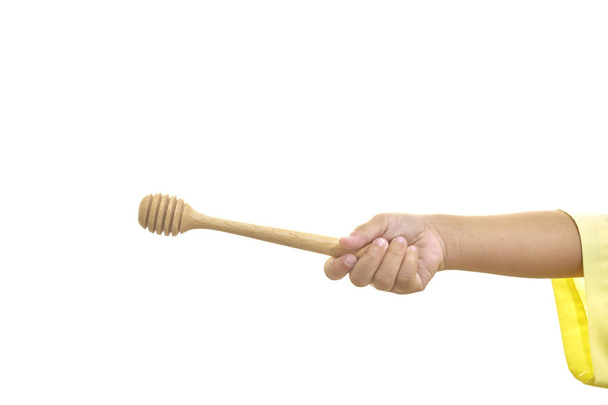 Hand of girl holding Wooden dipper for honey isolated on white background - Foto, immagini