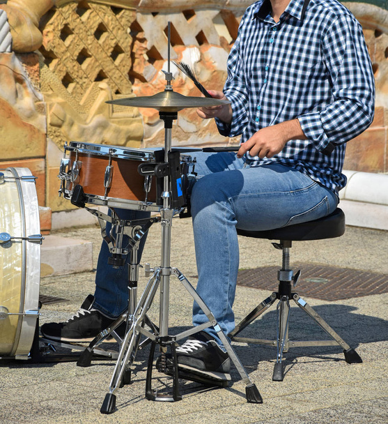 Drummer plays outdoor in summer time - Photo, Image