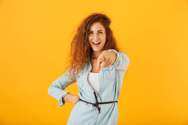 image of joyous european woman 20s pointing finger forward at you with smile isolated over yellow background - Φωτογραφία, εικόνα