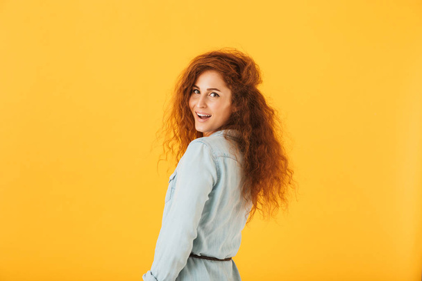 Portrait of beautiful young woman 20s with curly hair smiling at camera isolated over yellow background - Foto, Imagen