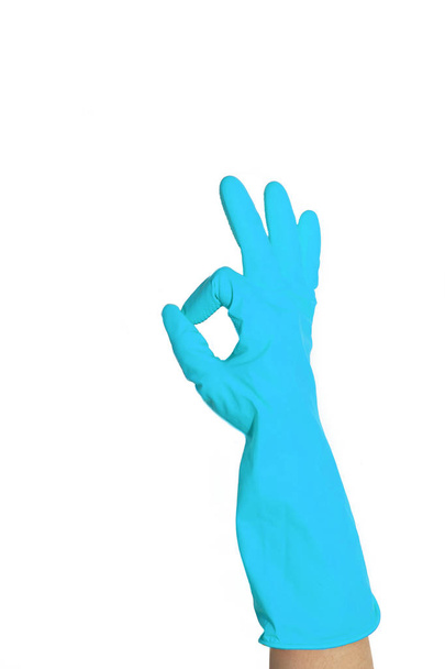 Ok sign of yellow rubber gloves. Preparing for cleaning. Hands clean after cleaning. Squeaky people. Wash floors, wash dishes. Rubber gloves on the hand. Rubber gloves on a hand on a white background. Rubber gloves for cleaning. - Photo, Image