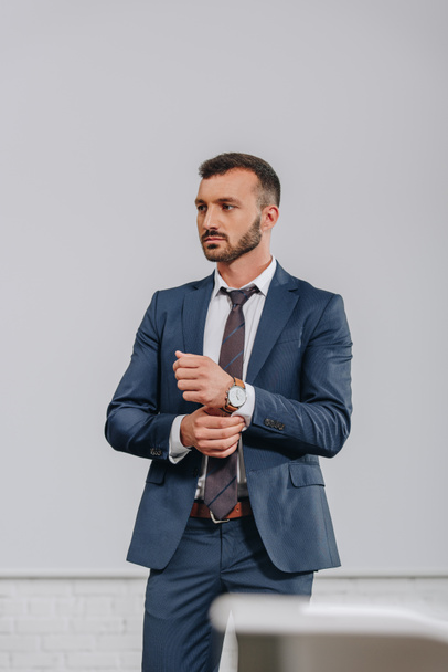 handsome businessman buttoning sleeve in hub - Photo, image