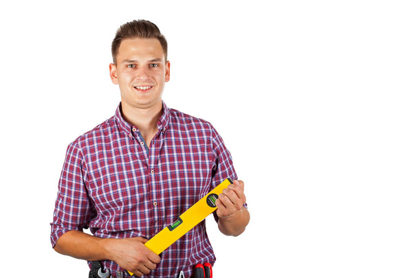 Portrait of handsome repairman holding tools,smiling to the camera on isolated - Φωτογραφία, εικόνα