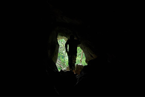 Tropical forest and man standing view from the cave : Nam Nao national park, Thailand - Foto, imagen