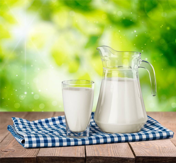 Glass of milk and jug on  table  - Foto, Imagen