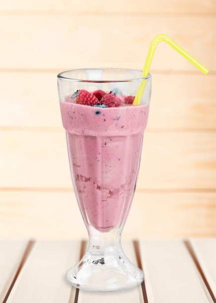 Glass of blueberry smoothie on light background - Photo, image