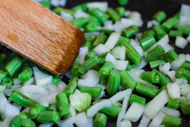 Coocking of green beans and garlic, fresh vegatables on wooden table - Valokuva, kuva