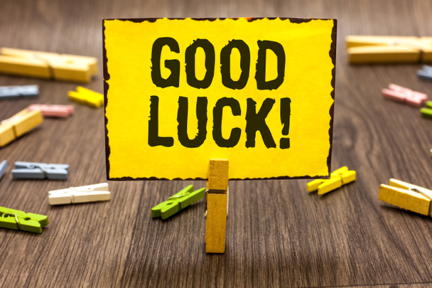 Text sign showing Good Luck. Conceptual photo A positive fortune or a happy outcome that a person can have Clothespin holding yellow paper note several clothespins wooden floor - Photo, Image
