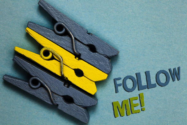 Conceptual hand writing showing Follow Me. Business photo text Inviting a person or group to obey your prefered leadership Gray yellow vintage clothespins clear background Holding things - Photo, Image