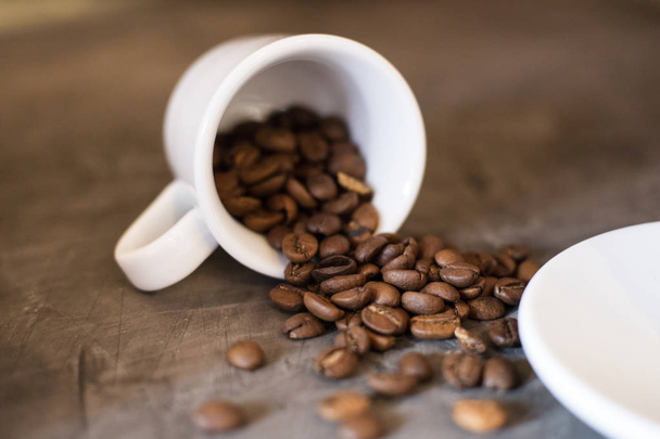 White cup and whole grains of coffee. Dark background  - Zdjęcie, obraz