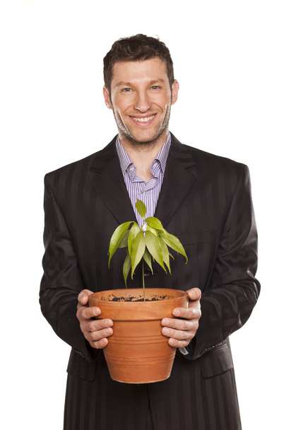 man holding pot with a tree - Фото, зображення