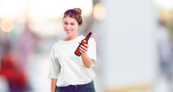 young beautiful girl happy with a beer bottle - Valokuva, kuva